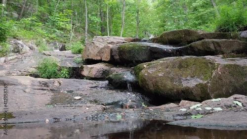 Stone outcrop cliff area water flow in Canada sightseeing pan left photo