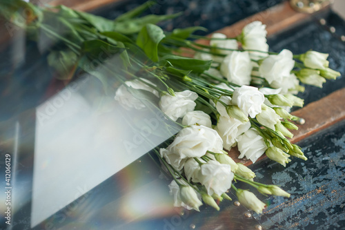 White Lisianthus on a vintage background. Prisms and reflections. Chromaticism. photo