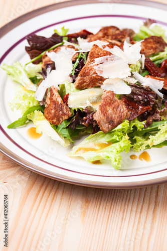 Fresh salad with meats in white plate