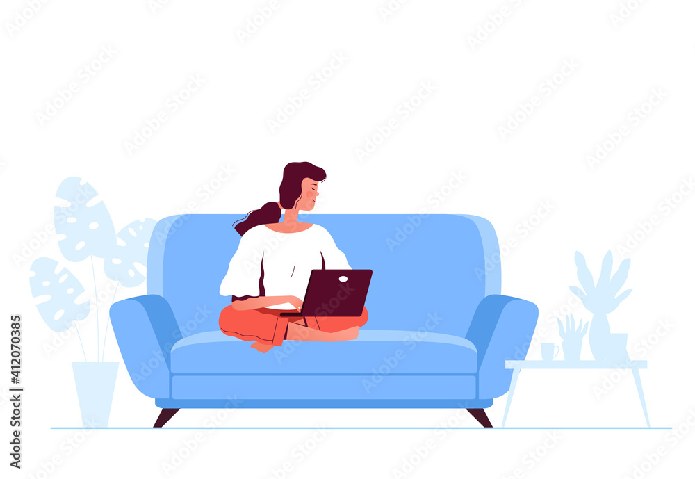 Young woman is sitting on a blue sofa with a laptop. Remote work and study concept Young woman is sitting on a blue sofa with a laptop. Remote work and study concept