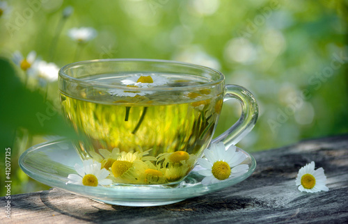 cup of chamomile tea on a wooden table. herbal tea. cold and flu remedy.  seletive focus photo