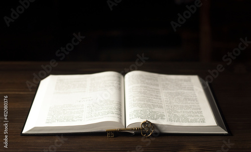 Open Bible. On the table. Holy Bible, Scripture. Old antique key.