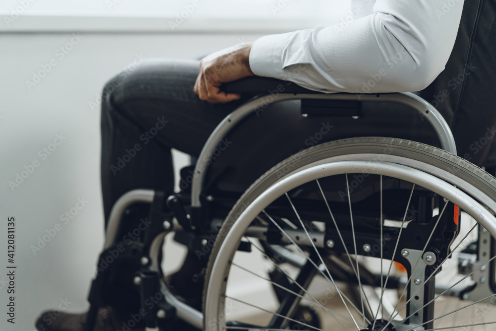 Unrecognizable man sitting in wheelchair close up Unrecognizable man sitting in wheelchair close up