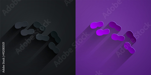 Paper cut Human footprints shoes icon isolated on black on purple background. Shoes sole. Paper art style. Vector.