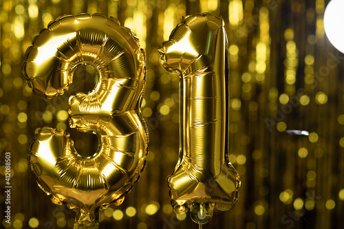 The golden number 31 thirty one is made from an inflatable balloon on a yellow background. One of the complete set of numbers. Birthday, anniversary, date concept