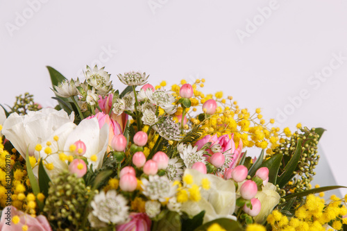 Floral arrangement with mimosa and animons on gray background 