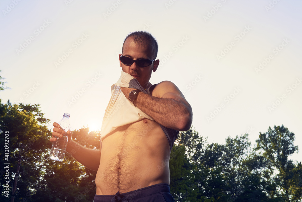 Sporty young adult man training in the park. Sporty young adult man training in the park.