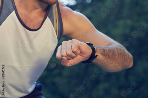 Sporty young adult man training in the park.