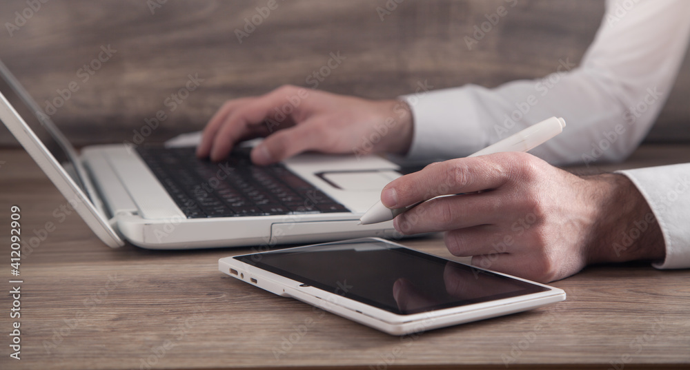 Graphic designer using tablet computer in office. Graphic designer using tablet computer in office.