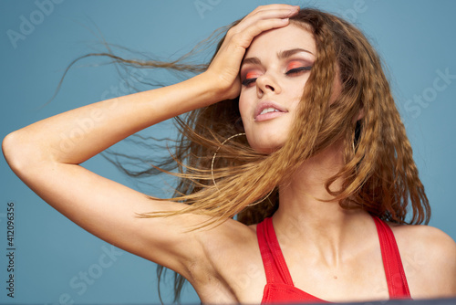 Attractive woman wavy hair charming look cosmetics elegant style blue background