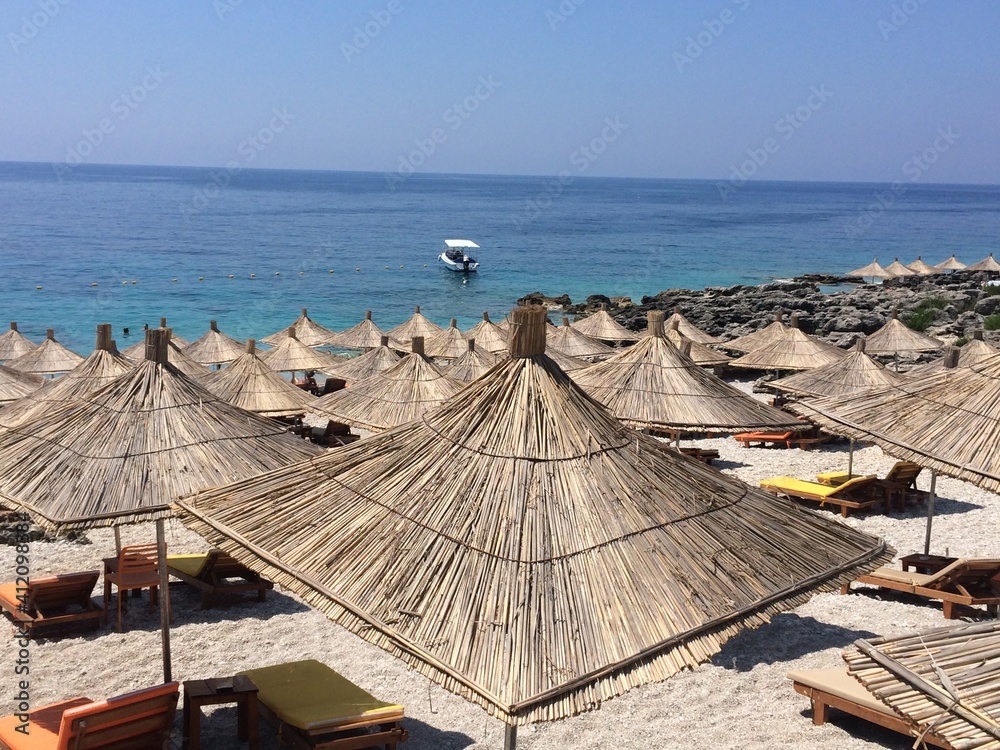 Straw umbrellas on a beach in Dhermi,Albania.