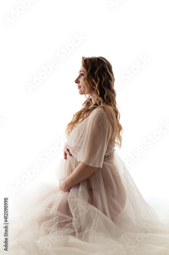 Pregnant girl on a light background