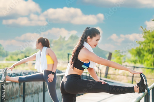 Two women best friends who take care of their health by exercising happily in the city. Health care concept