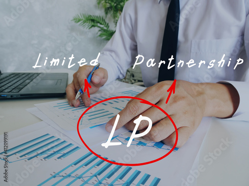 Conceptual photo about LP Limited Partnership with written abbreviation. Business Man Checking Documents on background. photo