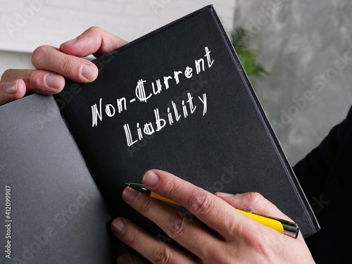  Financial concept meaning Non-Current Liability with inscription on the piece of paper.