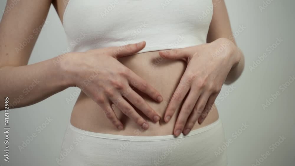 Close up of unrecognizable Caucasian woman checking her belly skin condition. Close up of unrecognizable Caucasian woman checking her belly skin condition.