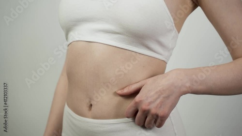 Wallpaper Mural Close up of unrecognizable Caucasian woman checking her belly skin condition. Torontodigital.ca