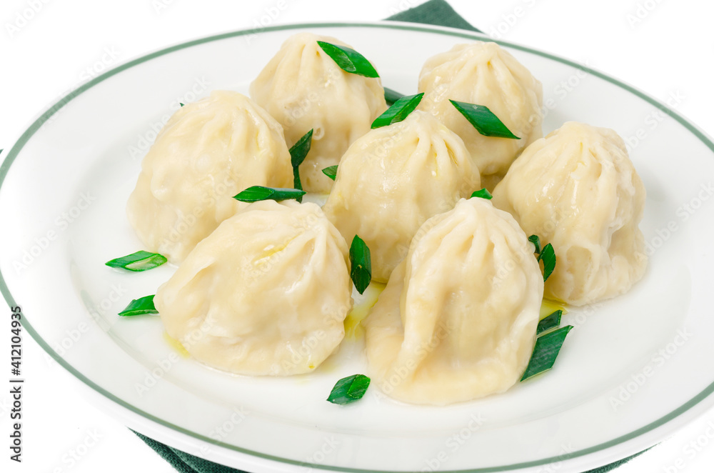 White plate with boiled khinkali, green onions. White plate with boiled khinkali, green onions.