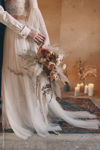 Boho style wedding bouquet in shades of brown, beige and white.