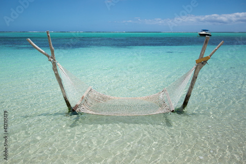 Empty over-water hammock in the middle of tropical lagoon