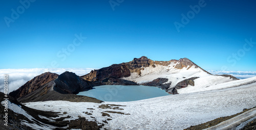 Mount ruapehu crater lake in summer with light snow photo