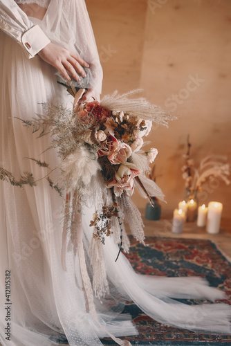 Boho style wedding bouquet in shades of brown, beige and white.