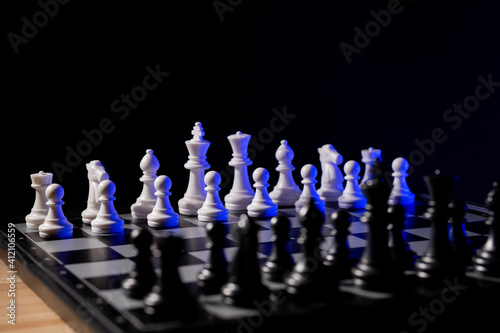 Business man chess at table. Player makes a move, developing chess strategy.