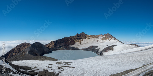 Mount ruapehu crater lake in summer with light snow photo