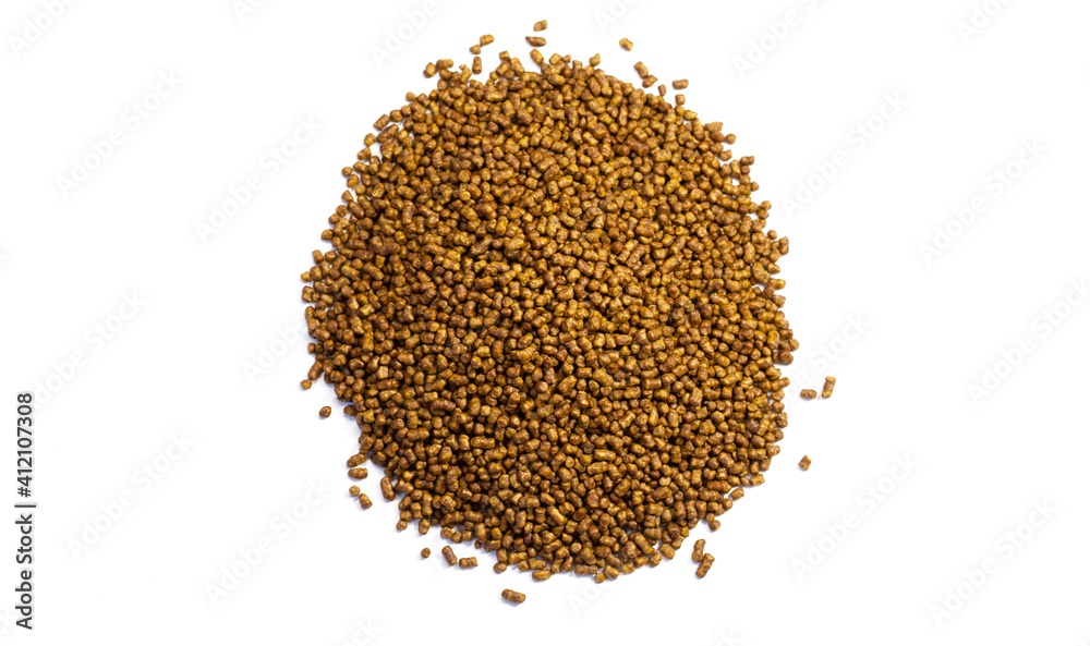 Buckwheat tea on a white background. Isolate. Buckwheat tea close-up macro photography. Scattered buckwheat tea pellets on white background top view. Buckwheat tea on a white background. Isolate. Buckwheat tea close-up macro photography. Scattered buckwheat tea pellets on white background top view.