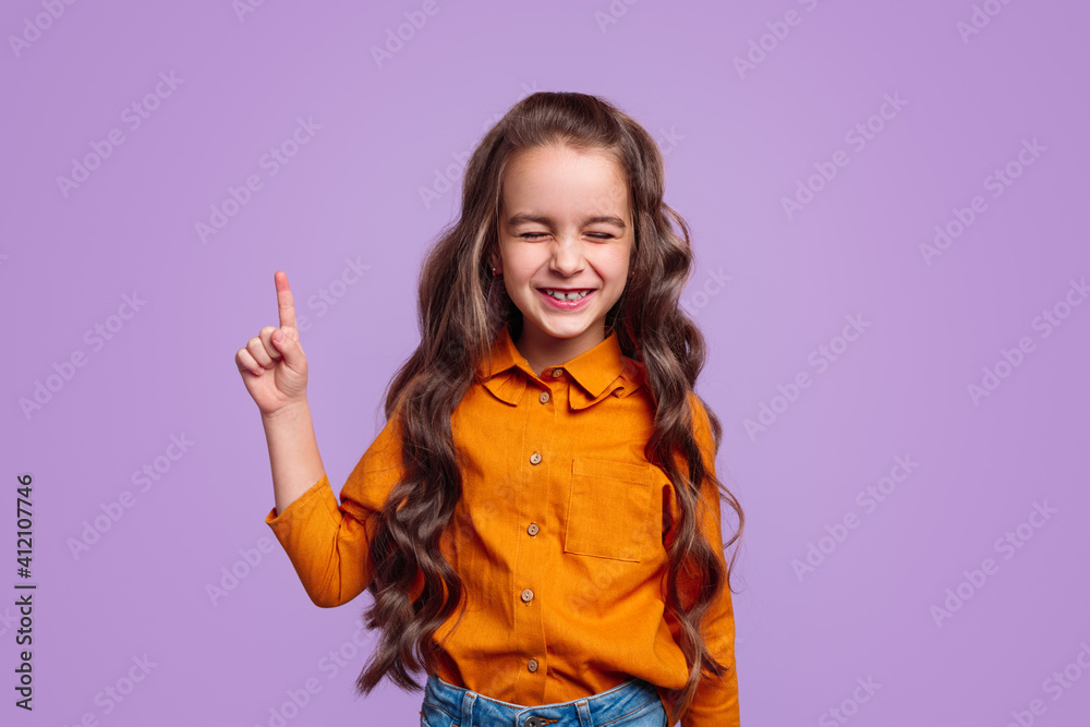 Cheerful girl pointing finger up Cheerful girl pointing finger up
