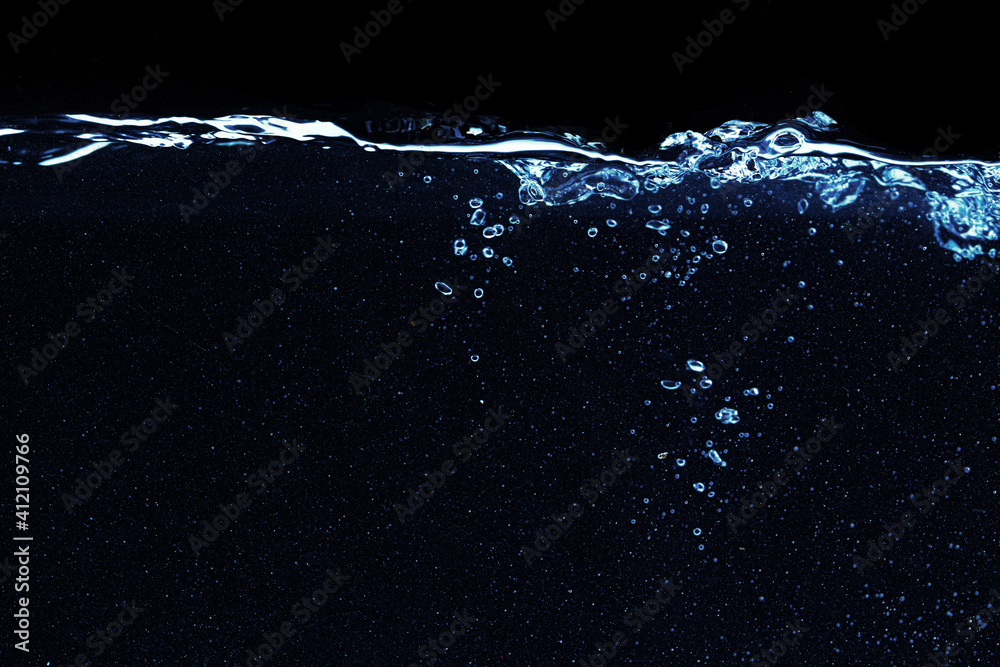 Water splash in aquarium isolated on black background
