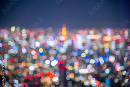 Night blurred bokeh light city office building, abstract background.