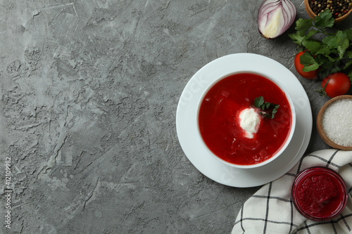 Concept of tasty eating with borscht on gray background
