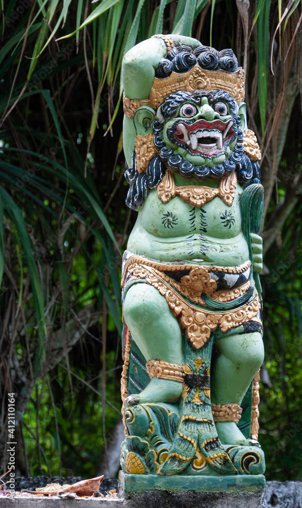A carved and painted wooden totem or statue of an Indonesian God