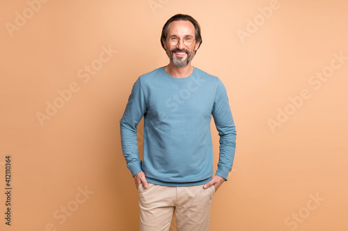 Obraz na plátně Photo of confident bearded business guy hands pockets wear eyewear blue pullover