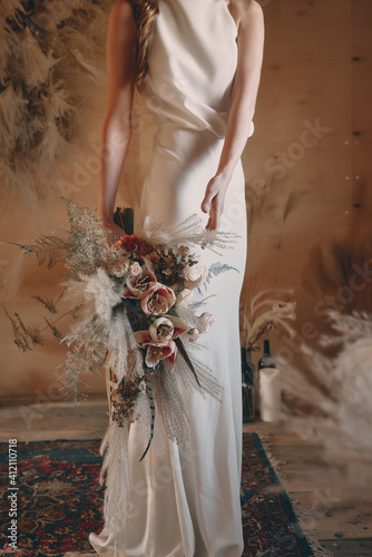 Boho style wedding bouquet in shades of brown, beige and white.