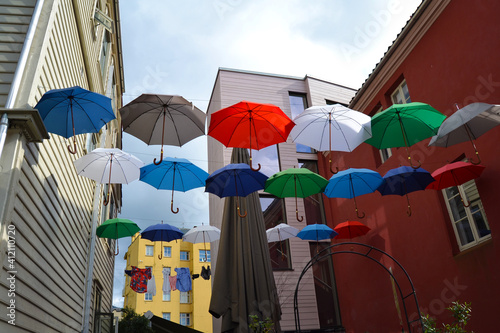 Hanging colorful umbrellas adorn the street in Bergen  Norway