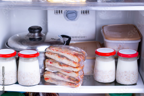 Frozen food in the freezer. Concept of storing ready made dinner and saving time.