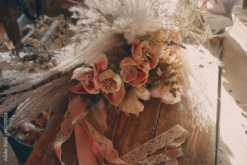 Boho style wedding bouquet in shades of brown, beige and white.