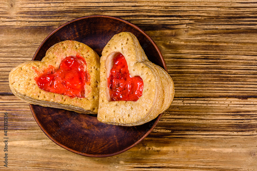 Pastry made in shape of heart on the wooden background