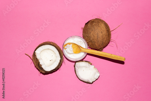 Half of coconuts isolated on color background. Coconut cream. Top View. Flat lay.