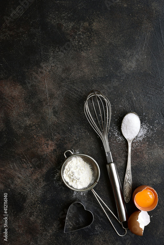 Culinary background with ingredients for baking : flour, egg and sugar. Top view with copy space.