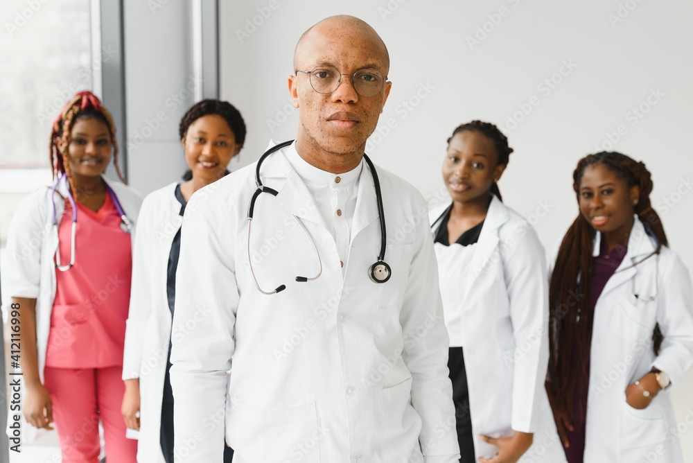 confident african medical doctor and colleagues portrait in hospital