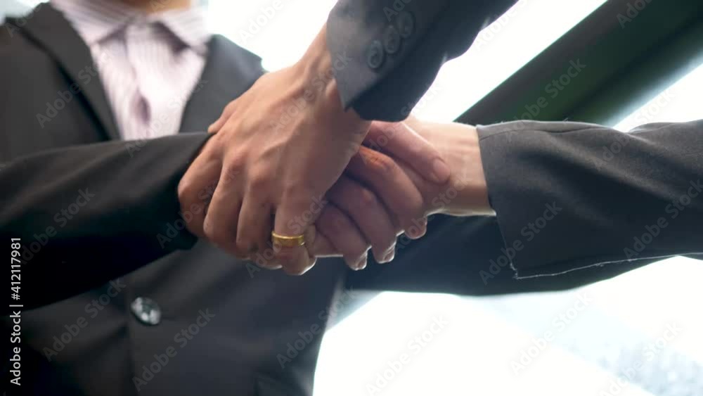 Holding hands with business partners to trust business partners, relationships to achieve future commercial and investment goals.