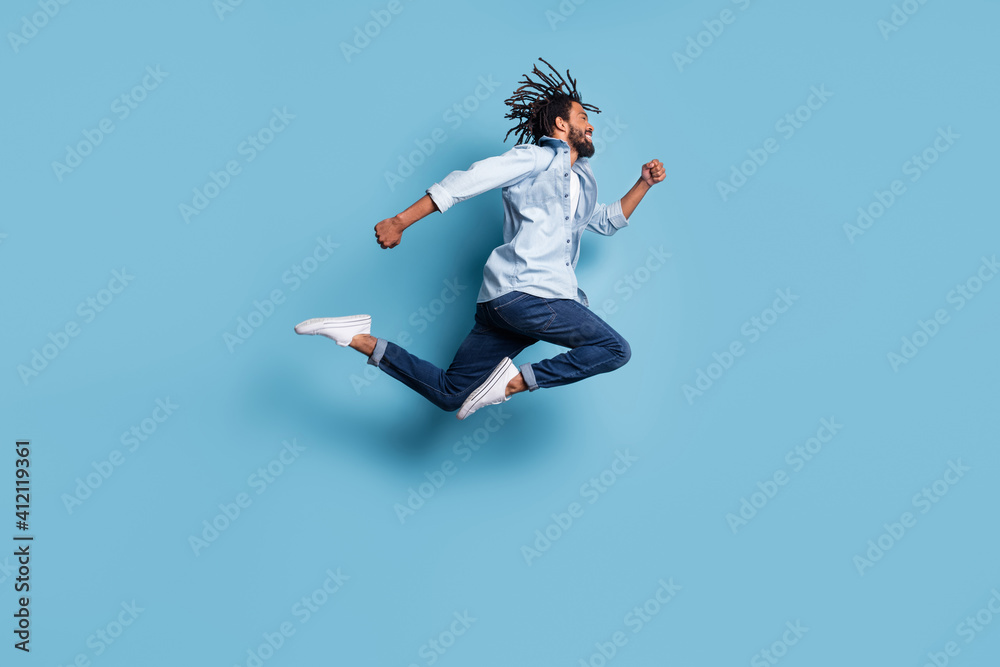 Full body profile photo of energetic dark skin person running hurry fast isolated on blue color background