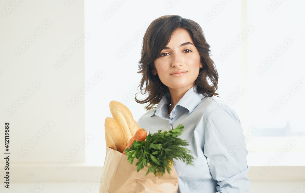 brunette with a package of groceries vegetables greens supermarket shopping brunette with a package of groceries vegetables greens supermarket shopping