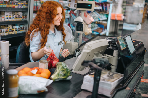 Photography Cashier scanning grocery products at checkout
