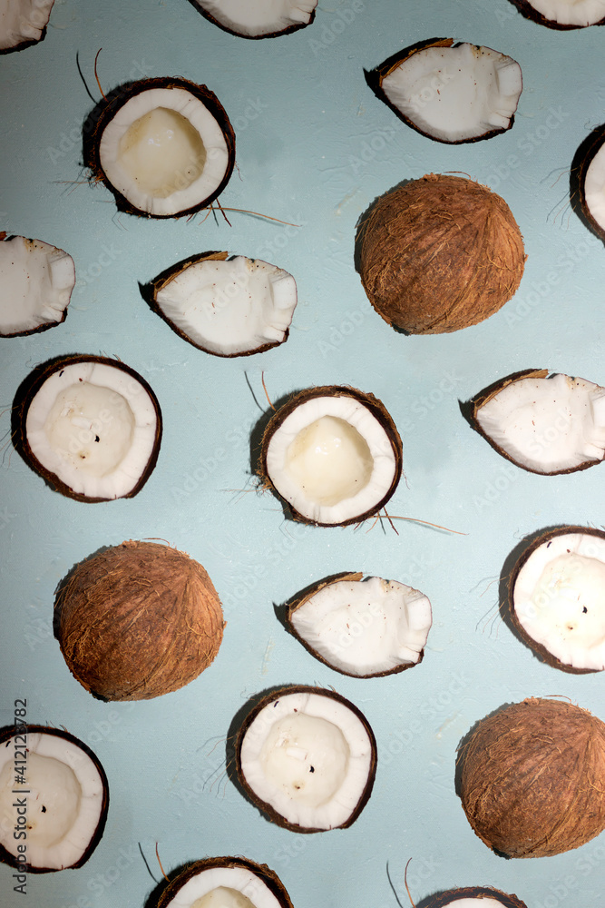 Half of coconuts isolated on color background. Coconut cream. Top View. Flat lay.