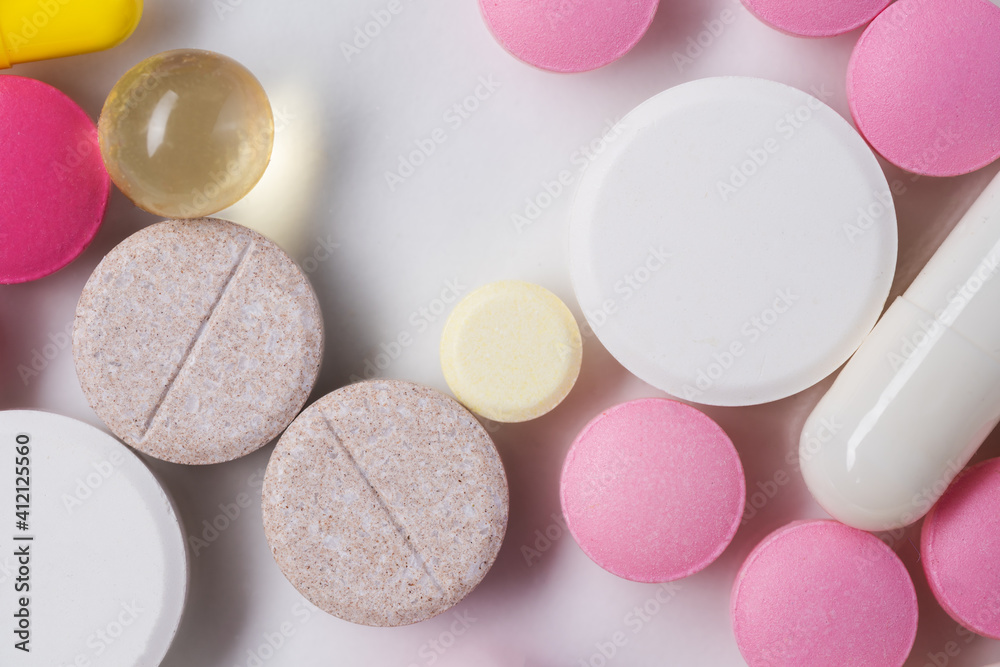 Multicolored pills and tablets on white background Multicolored pills and tablets on white background
