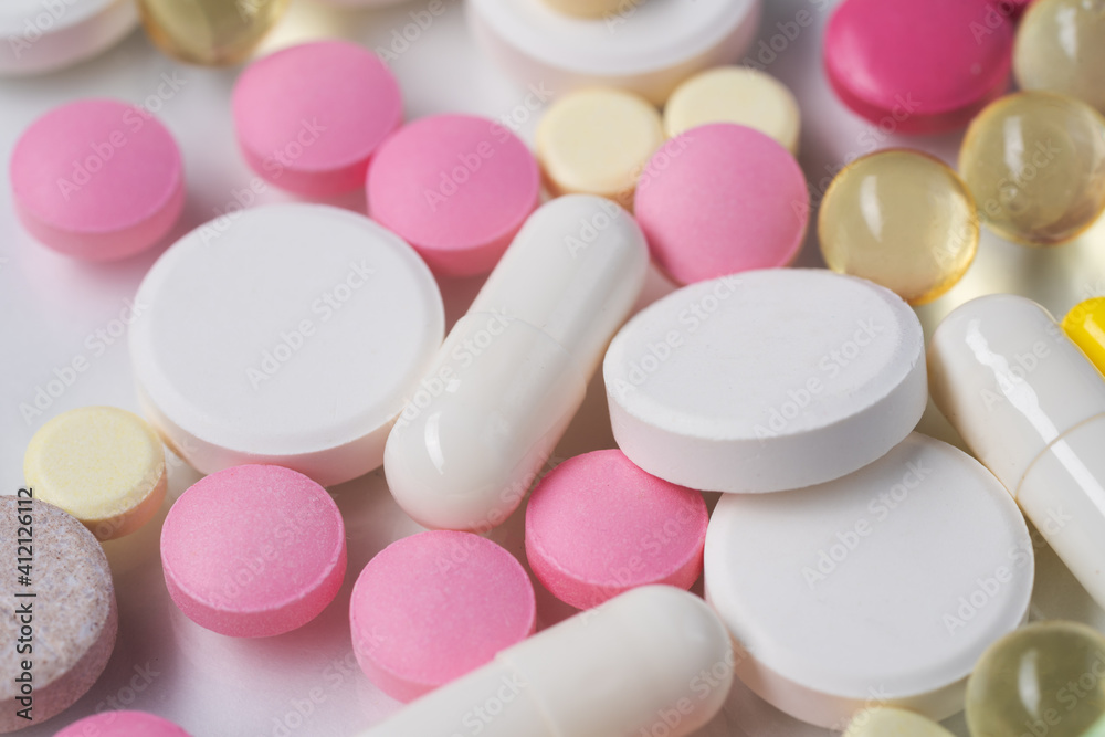 Multicolored pills and tablets on white background Multicolored pills and tablets on white background